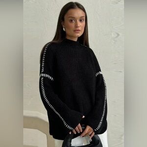 Elegant Black Mock Neck Sweater with White Detailing
